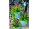 Three-tiered metal planters with lush greenery and purple flowers at 3242 Bonway Dr, Decatur, GA 30032