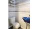 Modern powder room with blue vessel sink and white toilet at 3242 Bonway Dr, Decatur, GA 30032