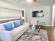 Bright living room features a neutral sofa and large TV at 3242 Bonway Dr, Decatur, GA 30032