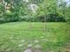 Spacious backyard with lush lawn, stepping stones, and mature trees at 3242 Bonway Dr, Decatur, GA 30032