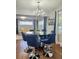 Elegant dining room with glass table and blue velvet chairs at 3242 Bonway Dr, Decatur, GA 30032