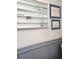 Bathroom with a glass-front cabinet and decorative wall paneling at 3242 Bonway Dr, Decatur, GA 30032