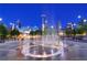 Night view of a city plaza with a circular fountain and city lights at 1858 Windemere Ne Dr, Atlanta, GA 30324