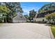 Spacious three-car garage with circular driveway and additional detached structure at 1170 Lowell Rd, Carrollton, GA 30116
