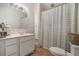 Clean bathroom with double vanity and shower/tub combo at 1170 Lowell Rd, Carrollton, GA 30116