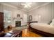 Bedroom with hardwood floors, fireplace, and window shutters at 1170 Lowell Rd, Carrollton, GA 30116