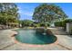 Relaxing pool with a waterfall feature and brick coping at 1170 Lowell Rd, Carrollton, GA 30116