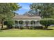 Charming farmhouse with a wraparound porch at 1170 Lowell Rd, Carrollton, GA 30116