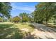 Gravel driveway surrounded by lush greenery and trees at 1170 Lowell Rd, Carrollton, GA 30116