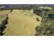 Aerial view of expansive property with large fields and mature trees at 1170 Lowell Rd, Carrollton, GA 30116