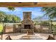 Stone outdoor kitchen with grill, fireplace, and pergola at 1170 Lowell Rd, Carrollton, GA 30116