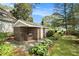 Brick outdoor smoker with stone patio and landscaping at 1170 Lowell Rd, Carrollton, GA 30116
