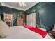 Jungle-themed bedroom with hardwood floors and ensuite bath at 1170 Lowell Rd, Carrollton, GA 30116