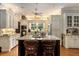 Large kitchen with granite island, custom cabinetry, and hardwood floors at 1170 Lowell Rd, Carrollton, GA 30116