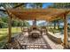 Outdoor patio with pergola, fireplace, and built-in grill at 1170 Lowell Rd, Carrollton, GA 30116