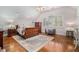 Bright bedroom with hardwood floors and a wood sleigh bed at 1170 Lowell Rd, Carrollton, GA 30116
