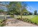 Brick paved driveway leading to a charming house with white fence at 1170 Lowell Rd, Carrollton, GA 30116