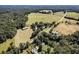 Aerial view showcasing a home, outbuildings, and surrounding land at 1170 Lowell Rd, Carrollton, GA 30116