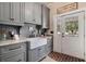 Functional laundry room with farmhouse sink and ample storage at 1170 Lowell Rd, Carrollton, GA 30116