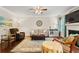 Comfortable living room with hardwood floors, ceiling fan and fireplace at 4550 Fernbrook Pl, Cumming, GA 30040