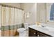 Clean bathroom with shower/tub combo and dark vanity at 4550 Fernbrook Pl, Cumming, GA 30040