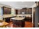 Spacious kitchen with granite countertops and dark wood cabinets at 4550 Fernbrook Pl, Cumming, GA 30040