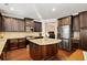 Open concept kitchen with granite island and stainless steel appliances at 4550 Fernbrook Pl, Cumming, GA 30040