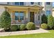 Inviting front porch with rocking chairs, landscaping, and a charming entrance at 4550 Fernbrook Pl, Cumming, GA 30040