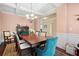 Bright dining room featuring a large wood table and access to hallway at 4550 Fernbrook Pl, Cumming, GA 30040
