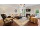 Cozy living room featuring hardwood floors, fireplace, and ceiling fan at 4550 Fernbrook Pl, Cumming, GA 30040