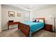 Bright bedroom with wooden bed frame and window seat at 4550 Fernbrook Pl, Cumming, GA 30040