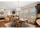 Bright dining area with hardwood floors and view into living room at 4550 Fernbrook Pl, Cumming, GA 30040