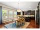 Eat-in kitchen with granite island, dark cabinetry, and stainless steel appliances at 4550 Fernbrook Pl, Cumming, GA 30040