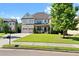 Two-story house with brick facade, three-car garage, and landscaped lawn at 4550 Fernbrook Pl, Cumming, GA 30040