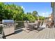Spacious deck with seating area, grill, and wooded backdrop at 4550 Fernbrook Pl, Cumming, GA 30040