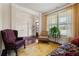 Spacious living room with hardwood floors, fireplace, and access to backyard at 4550 Fernbrook Pl, Cumming, GA 30040