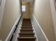 Elegant staircase with carpeted steps and dark railing at 490 Hill Se St, Atlanta, GA 30312
