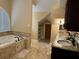 Primary bathroom with soaking tub, double vanity, and tile flooring at 490 Hill Se St, Atlanta, GA 30312