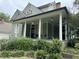 Two-story home with wrap-around porch and mature shrubs at 490 Hill Se St, Atlanta, GA 30312