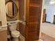 Small bathroom with toilet and a decorative mirror at 490 Hill Se St, Atlanta, GA 30312