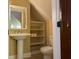 Small bathroom with pedestal sink, toilet and shelving unit at 490 Hill Se St, Atlanta, GA 30312