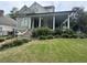 Two story green house with a large porch at 490 Hill Se St, Atlanta, GA 30312