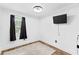 Simple bedroom with wood floors, a window, and a mounted TV at 6940 Cainwood Dr, Atlanta, GA 30349