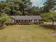 Ranch home with covered porch and landscaped yard at 1152 Harbins Rd, Dacula, GA 30019