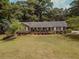 Ranch home with covered porch and landscaped yard at 1152 Harbins Rd, Dacula, GA 30019