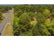 Property borders a paved road with woodland behind at 1152 Harbins Rd, Dacula, GA 30019