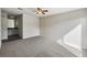 Spacious bedroom with gray carpet, ceiling fan and ensuite bathroom at 3301 Henderson Mill Rd # Z1, Atlanta, GA 30341