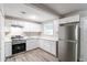 Modern kitchen with white cabinets, stainless steel appliances and quartz countertops at 1669 Freedom Vly, Decatur, GA 30032
