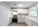 Modern kitchen with white cabinets, stainless steel appliances and quartz countertops at 1669 Freedom Vly, Decatur, GA 30032