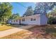 Newly renovated light blue house with red door, driveway and landscaping at 1669 Freedom Vly, Decatur, GA 30032